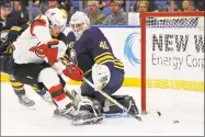  ?? Jeffrey T. Barnes / Associated Press ?? Devils forward Miles Wood puts the puck past Sabres goalie Robin Lehner during the second period Tuesday in Buffalo, N.Y.