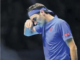  ??  ?? TIM IRELAND/AP Switzerlan­d's Roger Federer wipes his face during his ATP Finals match against Japan's Kei Nishikori at the O2 Arena in London, Britain, on November 11, 2018.