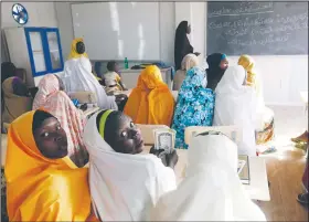  ?? AP/SUNDAY ALAMBA ?? Children displaced by Boko Haram during an attack on their villages receive lectures Dec. 7, 2015, in a school in Maiduguri, Nigeria.