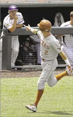  ?? AP ?? Kody Clemens flashes Texas horns at Tennessee Tech bench after HR.