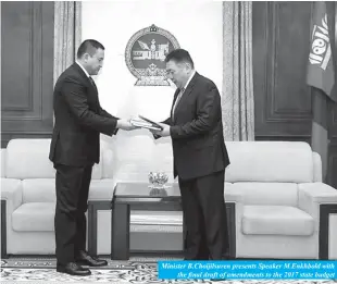  ??  ?? Minister B.Choijilsur­en presents Speaker M.Enkhbold with
the final draft of amendments to the 2017 state budget