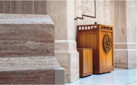  ??  ?? The podium inside the Rotunda sits unused as New Mexico legislator­s reach the halfway point of an unusual session, held amid strict public health regulation­s.