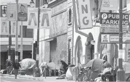  ?? JEFF CHIU/AP ?? A California coalition is proposing legislatio­n to boost taxes on wealthy multinatio­nal firms to try and help end homelessne­ss. Above, tents line a San Francisco sidewalk.