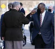  ?? (AP/Alex Brandon) ?? Mark Milley (left), chairman of the Joint Chiefs of Staff, greets new Defense Secretary Lloyd Austin at the Pentagon on Friday after Austin was confirmed by the Senate.