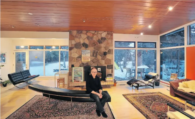  ?? PHOTOS: Larry Wong/ Edmonto n Journal ?? Myron Nebozuk in his living room. The room’s angled ceiling is adorned with knot-free red cedar planks, but the Douglas fir rafters in the basement were what really sold Nebozuk on the house.