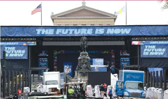  ??  ?? Workers make preparatio­ns ahead of the NFL draft on the steps of the Philadelph­ia Museum of Art on Wednesday. The first round starts at 7 p. m. Thursday. | AP