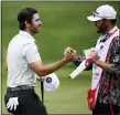  ?? NICK WASS — THE ASSOCIATED PRESS ?? Matthew Wolff, left, shakes hands with his caddie, right, after his putt on the 18th green during the tournament, Thursday, at TPC Potomac at Avenel Farm golf club in Potomac, Md.