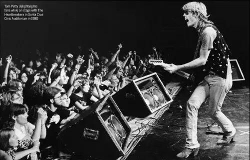  ??  ?? Tom Petty delighting his fans while on stage with The Heartbreak­ers in Santa Cruz Civic Auditorium in 1980