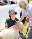  ?? ?? Judge Diana Timms inspects Evie, who belongs to Poroutawha­o School student Tahlia Parata, 12.