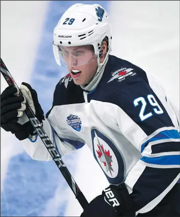  ??  ?? Patrik Laine broke out of his scoring slump yesterday against the Panthers. Former Jet Temmue Selanne (below left) said Laine just needs to relax with the puck.