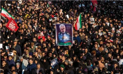  ?? Photograph: Majid Saeedi/Getty Images ?? Mourners attend a funeral ceremony for Qassem Suleimani in January last year in Tehran. The Trump White House wanted to play down injuries to US troops in reprisals by Iran, a former defense spokeswoma­n has said.