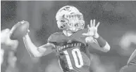  ?? JENNIFER LETT/SUN SENTINEL ?? Chaminade-Madonna quarterbac­k Daelen Menard looks for a receiver in the game against American Heritage.