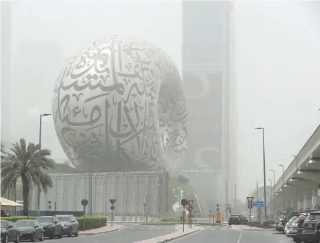  ?? Pawan Singh and Khushnum Bhandari / The National ?? Dubai’s Museum of the Future during the dusty weather. Left, a hazy day in Abu Dhabi