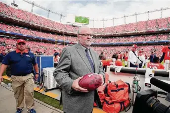  ?? Jack Dempsey/Associated Press ?? Hall of Fame representa­tive Joe Horrigan carries the football that Broncos quarterbac­k Peyton Manning threw to move into first place for all-time passing yards on Nov. 15, 2015 in Denver.