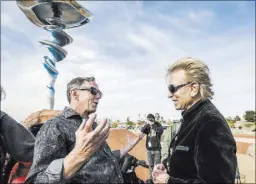  ?? JEFF SCHEID LAS VEGAS REVIEW-JOURNAL ?? Artist Wayne Littlejohn, left, joins illusionis­t Siegfried Fischbache­r at the dedication of Littlejohn’s “Dream Machine” sculpture at Siegfried & Roy Park, across the street from McCarran Internatio­nal Airport.