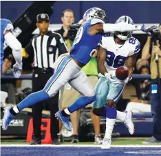  ?? (Reuters) ?? DALLAS COWBOYS receiver Dez Bryant (88) catches a first-half touchdown while being covered by Detroit Lions cornerback Johnson Bademosi during the Cowboys’ 42-21 home victory on Monday night. Despite losing a second straight game, the Lions (9-6) still...