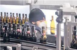  ?? MARTIN MEISSNER/AP ?? An employee at work Tuesday at Brauerei Heller in Cologne, Germany. Many of the country’s small breweries rely heavily on selling beer to bars and restaurant­s.