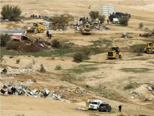  ??  ?? Bulldozers demolish Bedouin homes in the village of Umm al-Hiran in the Negev Desert, southern Israel (EPA)