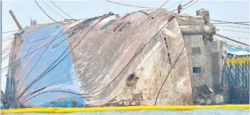  ??  ?? The sunken ferry Sewol is seen during its salvage operations on the sea off Jindo. — Reuters photo