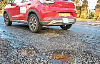  ?? ?? Traffic nightmare: The pothole problem will now take ten years to fix