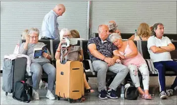  ?? PIC/PTI ?? British passengers wait for news on cancelled Thomas Cook flights at Palma de Mallorca airport on Monday