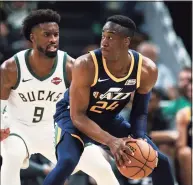  ?? Dylan Buell / Getty Images ?? Miye Oni of the Utah Jazz handles the ball while being guarded by Wesley Matthews of the Milwaukee Bucks in 2019.