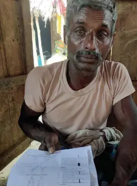  ??  ?? Ram Chhabiley of Shravasti’s Bangha village with the postmortem report of his son Mukesh, who was returning from Ludhiana but died on the bus