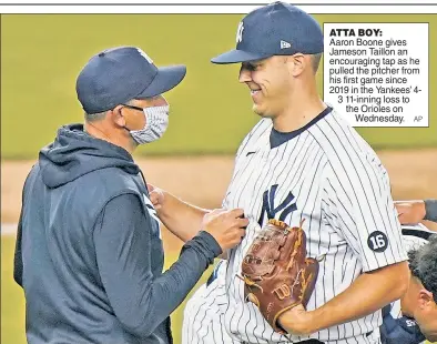  ?? AP ?? ATTA BOY:
Aaron Boone gives Jameson Taillon an encouragin­g tap as he pulled the pitcher from his first game since 2019 in the Yankees’ 43 11-inning loss to the Orioles on
Wednesday.