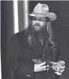  ?? PHOTO BY CHARLES SYKES/INVISION/AP ?? Chris Stapleton accepts the award for single of the year for “Broken Halos” at the 52nd annual CMA Awards on Wednesday in Nashville.