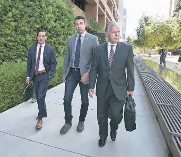  ?? John Gibbins San Diego Union-Tribune ?? REP. DUNCAN HUNTER, center, with attorneys Devin Burstein, left, and Gregory Vega in August. Federal prosecutor­s are petitionin­g to disqualify an attorney slated to join Hunter’s defense team in his criminal trial.