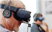  ?? [PHOTO BY DOUG HOKE, THE OKLAHOMAN ARCHIVES] ?? Frank Towerly, of Norman, takes part in a virtual reality/360 film experience at the 21c Museum Hotel during the 2017 deadCenter Film Festival in downtown Oklahoma City.