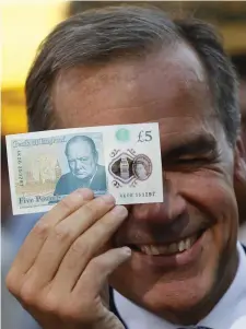  ??  ?? Bank of England governor Mark Carney launching a new five pound note featuring a portrait of Winston Churchill