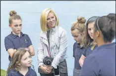  ??  ?? Kate T. Parker talks with girls who are featured in her new photo book, “Strong Is the New Pretty,” at Atlanta Academy. Her book covers girls from the Atlanta area and around the country.