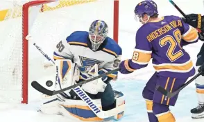  ?? MARK J. TERRILL/AP ?? Kings center Jaret Anderson-Dolan, right, tries to get a shot past Blues goaltender Jordan Binnington on Wednesday in Los Angeles.