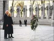  ?? Evan Vucci Associated Press ?? PRESIDENT BIDEN and the first lady pay their respects at the National World War II Memorial.