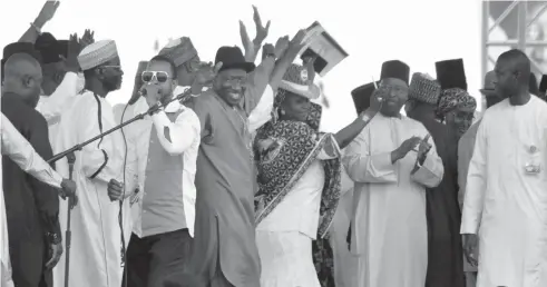 ?? PHOTO: SANI MAIKATANGA ?? President Goodluck Jonathan (middle) dancing to music supplied by Sani Danja,
during the formal acceptance
of former Kano State governor, Malam Ibrahim Shekarau, to PDP in Kano
yesterday.