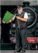  ?? ?? North Yorkshire Moors Railway guard Bob Howitt signals the start of what looks set to be a second successful Love Your Railway campaign. CHARLOTTE GRAHAM/NYMR