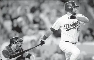  ?? Alex Gallardo Associated Press ?? ANDRE ETHIER delivers the key hit in the Dodgers’ four-run seventh inning, a two-run single off the Cubs’ Jon Lester that broke a 2-2 tie. Chicago catcher Miguel Montero watches the play.