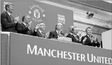  ?? — Photo by The Associated Press ?? Executives from Manchester United, including Avram Glazer (fourth from left) and Joel Glazer (third from left) applaud after ringing the opening bell at the New York Stock Exchange Friday in New York.