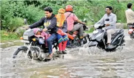  ??  ?? Motorists negotiate a flooded road in Nacharam on Tuesday — DC