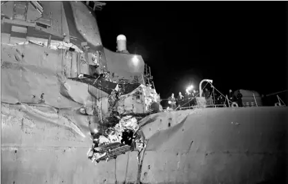  ?? — Photo by The Associated Press/u.s navy ?? In this image released by the U.S. navy, the U.S. navy’s guided-missile destroyer is seen damaged after it collided with a Japanese-owned oil tanker just outside the strategic Strait of Hormuz, Sunday. The collision left a gaping hole in the starboard...