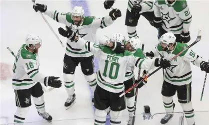  ??  ?? Dallas Stars right wing Corey Perry (10) is congratula­ted for his goal against the Tampa Bay Lightning during the second overtime of Saturday’s Game 5. Photograph: Jason Franson/AP