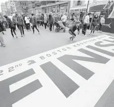  ?? MICHAEL DWYER/AP ?? People gather at the Boston Marathon finish five-year anniversar­y of the bombings. line in Boston on Sunday, the