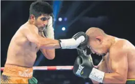  ?? PTI PHOTO ?? Boxer Vijender Singh in action against his Chinese opponent Zulpilkar Maimaitial­i during their ‘Battlegrou­nd Asia’ bout in Mumbai on Saturday.
