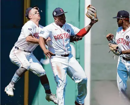  ?? Michael Dwyer/Associated Press ?? Boston Red Sox’s Rafael Devers, center, collides with teammate Tyler O’Neil after making the catch on a pop out by Cleveland Guardians’ Estevan Florial as Ceddanne Rafaela, right, looks on during the seventh inning Monday in Boston.