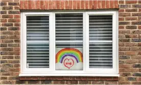  ??  ?? A homemade drawing of a rainbow in a house window in Aylesbury, England. Photograph: Catherine Ivill/Getty Images