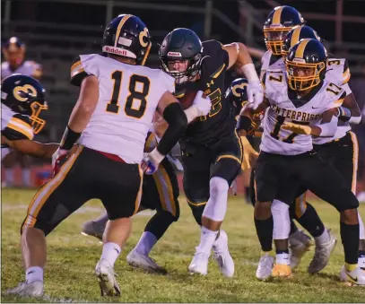  ?? PHOTOS BY MATT BATES — ENTERPRISE-RECORD ?? Paradise’s Tyler Harrison, center, tries to run through several Enterprise defenders Sept. 9 during the Bobcats’ home matchup against the Hornets in Paradise.