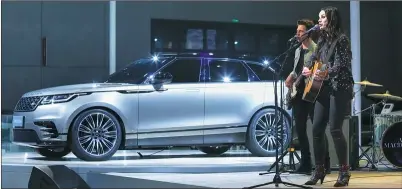  ?? PHOTOS ROVIDED TO CHINA DAILY ?? British pop star Amy McDonald performs to debut Land Rover’s brand new Range Rover Velar at the Shanghai auto show on Wednesday.