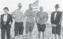  ??  ?? From left to rigt: Debra Case, Commission­er Kevin Biederman, Mayor Josh Levy, lifeguard chief Bruce Wilkie, Terrence Case. About 150 people showed up for a breakfast on the Broadwalk, and to watch the revered rodent on TV, before splashing into the 60-degree ocean waters.