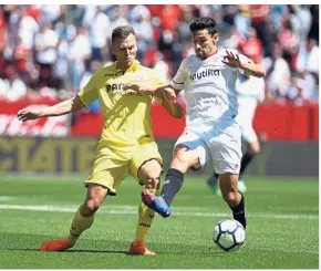  ??  ?? Heated contest: Sevilla’s Jesus Navas (right) vying for the ball with Villarreal’s Denis Cheryshev during the La Liga match at the Ramon Sanchez Pizjuan yesterday. — AFP